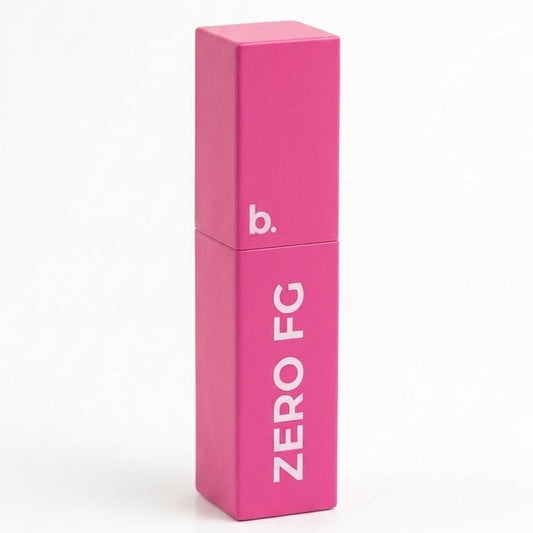 A bright pink rectangular cosmetic tube with a matching cap, standing upright on a white background. The tube features the text 'ZERO FG' in white and a small 'b.